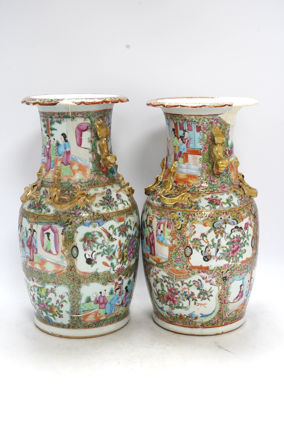 A pair of 19th century Chinese Canton famille rose vases, 36cm high. Condition - poor